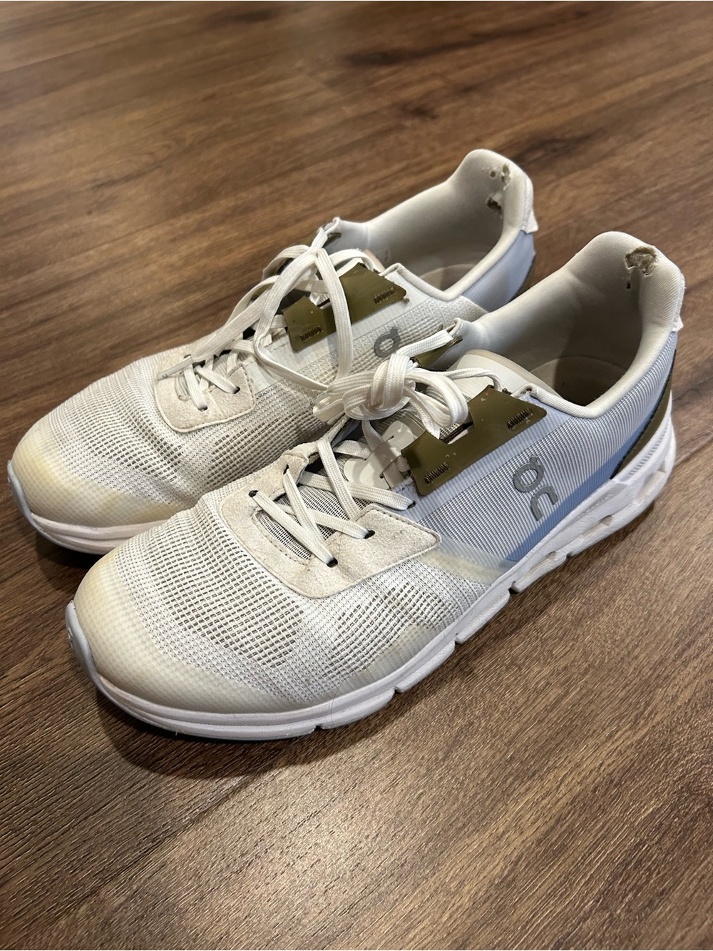 On Running Women’s Cloud Sneakers in White with Gold Accents